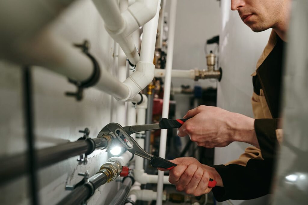 Plumbers maintaining commercial plumbing pipes in Highland